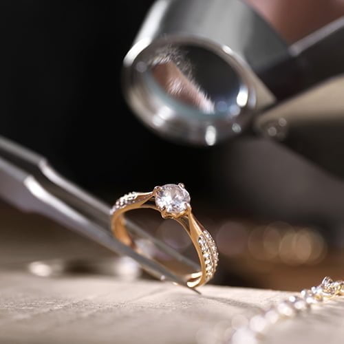 Diamond ring valuation Diamond engagement ring being evaluated for cash sale at jewellery shop