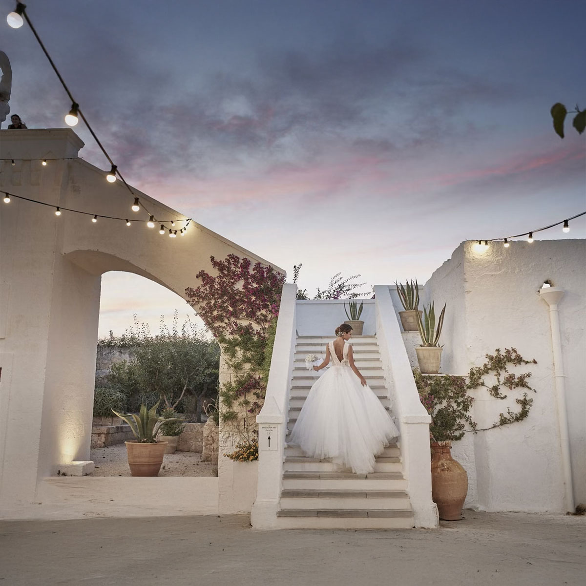 woman dressed as bride in a staircase