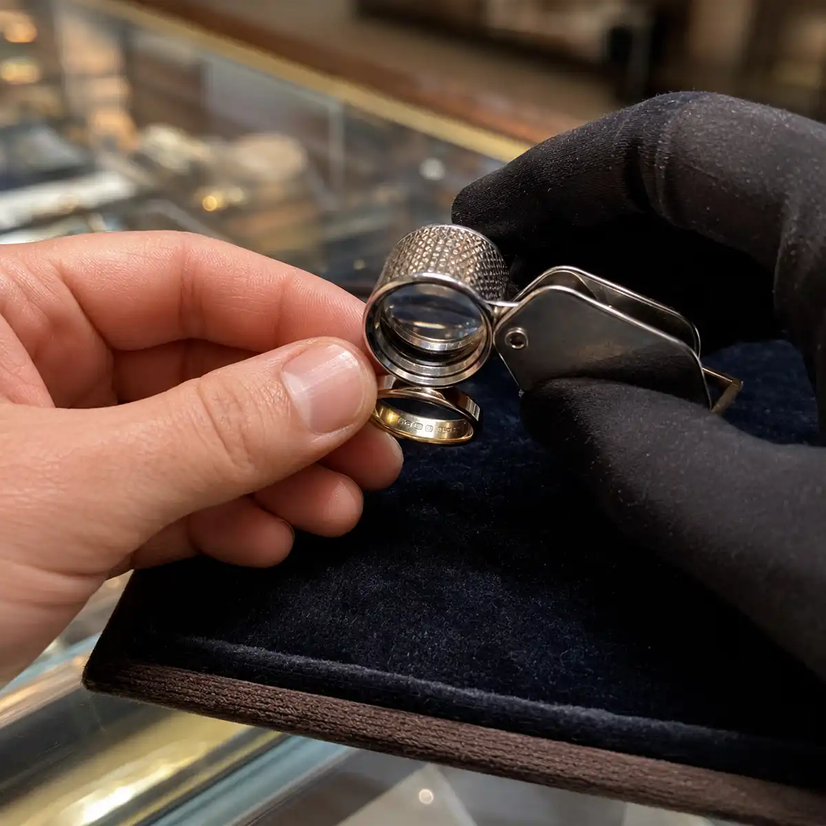 Date letter and fineness mark detail Date letter and fineness mark inside a gold ring shank illustrating how to read a British hallmark with a 10x loupe