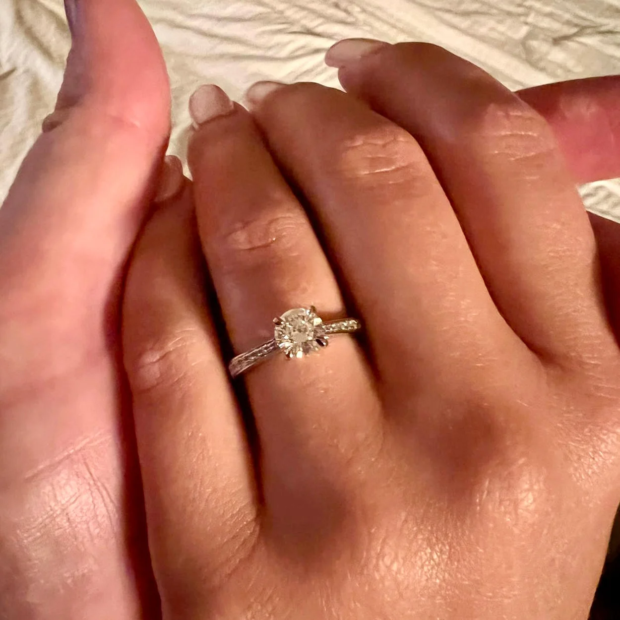 Diamond solitaire engagement ring worn on the hand, Barrett Jewellery Hatton Garden